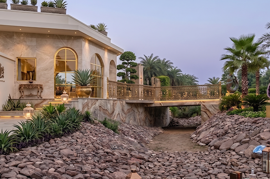 Palms & Pebbles — pebble landscape and estate buildings